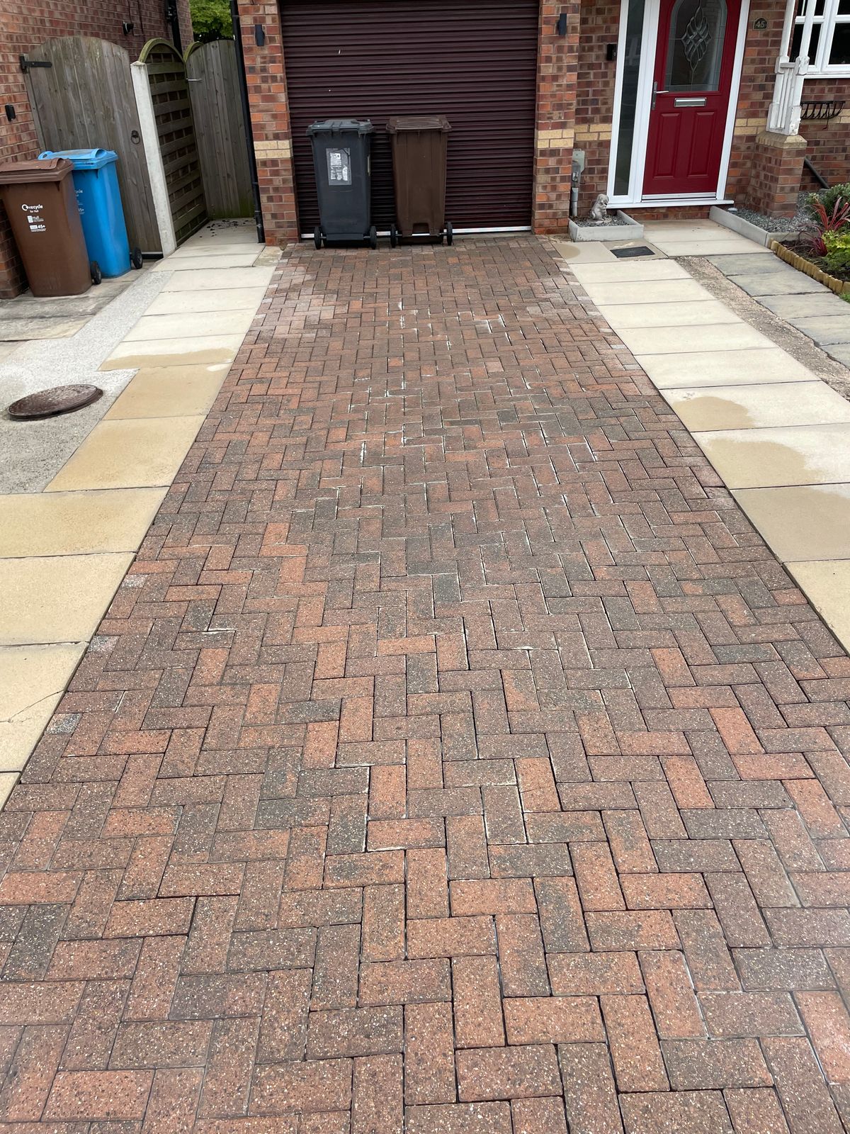 Freshly pressure washed and oil-treated block paving driveway